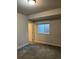 Cozy bedroom featuring carpet flooring, a window with blinds, and a view of the door frame at 226 S Shady Grove Ct, Aurora, CO 80018