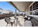 Relaxing covered patio with ample seating, perfect for outdoor entertaining and dining at 226 S Shady Grove Ct, Aurora, CO 80018