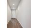 Entryway hallway featuring modern lighting, durable wood floors, and a neutral color palette at 226 S Shady Grove Ct, Aurora, CO 80018