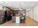 Spacious kitchen with center island, stainless steel appliances, and dark wood cabinetry at 226 S Shady Grove Ct, Aurora, CO 80018