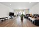 Open concept living room features wood floors, abundant natural light, and comfortable seating at 226 S Shady Grove Ct, Aurora, CO 80018