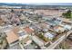Aerial view of a residential neighborhood with tree-lined streets, and homes with well-maintained yards at 4764 High St, Denver, CO 80216