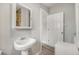 Bathroom features a pedestal sink, medicine cabinet, toilet, and access to another bathroom at 4764 High St, Denver, CO 80216