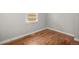 Neutral bedroom with hardwood floors, base trim and natural light at 4764 High St, Denver, CO 80216