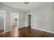Light-filled room with hard wood flooring and multiple door frames at 4764 High St, Denver, CO 80216