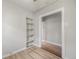 A bright bedroom with built-in shelving and durable laminate floors at 4764 High St, Denver, CO 80216