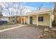 Quaint home with covered porch, security door, and low-maintenance gravel yard at 4764 High St, Denver, CO 80216