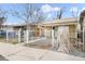 Home with a white wrought iron fence and xeriscaped yard at 4764 High St, Denver, CO 80216