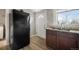 This home features a functional kitchen with tile countertops, wooden cabinets and modern appliances at 4764 High St, Denver, CO 80216