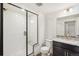 Sleek bathroom featuring a walk-in shower with a black framed shower door, and a vanity at 9274 Biscay St, Commerce City, CO 80022