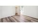 A bright bedroom with gray wood flooring, a closet, and a window at 9274 Biscay St, Commerce City, CO 80022