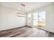 Contemporary dining area with a modern chandelier and sliding glass door access to backyard at 9274 Biscay St, Commerce City, CO 80022