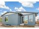 Rear exterior view of home featuring sliding glass door, small window, and gray siding at 9274 Biscay St, Commerce City, CO 80022