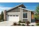 Modern single-story home with gray siding and attached garage at 9274 Biscay St, Commerce City, CO 80022