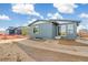 Rear exterior view of home featuring sliding glass door, small window, and gray siding at 9274 Biscay St, Commerce City, CO 80022