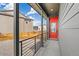 Inviting front porch featuring a bright red front door and modern metal railings at 9274 Biscay St, Commerce City, CO 80022