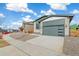 Beautiful home exterior showcasing an attached garage, modern brick accents, and long driveway at 9274 Biscay St, Commerce City, CO 80022