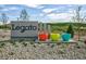 Community entrance sign for Legato, showcasing vibrant landscaping and modern design at 9274 Biscay St, Commerce City, CO 80022