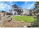Beautiful backyard with a cozy patio, outdoor seating, and lush green grass, perfect for entertaining at 1174 Williams Loop, Elizabeth, CO 80107