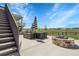 Expansive backyard with a fire pit, seating, and views of the neighborhood beyond the fence at 1174 Williams Loop, Elizabeth, CO 80107