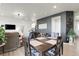 Inviting dining area with wood table, chairs, and hardwood flooring with views into the living room at 1174 Williams Loop, Elizabeth, CO 80107