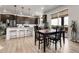 Open kitchen and dining area featuring stainless steel appliances, granite countertops, and hardwood flooring at 1174 Williams Loop, Elizabeth, CO 80107
