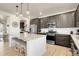 Beautiful kitchen features stainless appliances, granite countertops, and a large island with seating at 1174 Williams Loop, Elizabeth, CO 80107