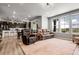 Spacious open-concept living room with hardwood flooring and great natural light with kitchen in the background at 1174 Williams Loop, Elizabeth, CO 80107