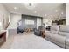 Open-concept living area with hardwood flooring, custom wall accents, and modern furnishings with staircase to upper level at 1174 Williams Loop, Elizabeth, CO 80107