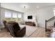 Bright living room featuring a shiplap wall, large windows, and modern furnishings and hardwood floors at 1174 Williams Loop, Elizabeth, CO 80107
