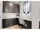 Office area includes custom cabinets, granite countertops, a comfortable chair, and bright window at 1174 Williams Loop, Elizabeth, CO 80107