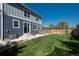Two-story home with an outdoor patio area, fenced yard, and string lights at 7958 Tejon St, Denver, CO 80221