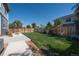Fenced backyard featuring a well-maintained lawn, patio area, and string lights above at 7958 Tejon St, Denver, CO 80221
