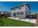 Backyard featuring a well-maintained lawn, patio area with seating, and string lights at 7958 Tejon St, Denver, CO 80221