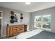 Bedroom featuring a rustic wood dresser, decorative hats, and a scenic view from the window at 7958 Tejon St, Denver, CO 80221