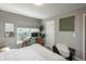 Bedroom with a home office area, a comfortable reading chair, and bright natural lighting at 7958 Tejon St, Denver, CO 80221
