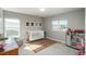 Bright Bedroom featuring a crib, a large window, and a play kitchen at 7958 Tejon St, Denver, CO 80221