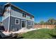Two-story home with an outdoor patio area, fenced yard, and string lights at 7958 Tejon St, Denver, CO 80221