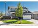 Charming two-story home with a well-manicured lawn, attached two car garage, and a welcoming front porch at 7958 Tejon St, Denver, CO 80221