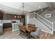 Open-concept kitchen with an adjacent dining area and staircase, perfect for entertaining and Gathering gatherings at 7958 Tejon St, Denver, CO 80221