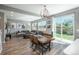 Open living room area with an oversized gray couch and a backyard view from surrounding windows at 7958 Tejon St, Denver, CO 80221