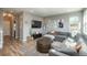Comfortable living area with a large gray sectional and rustic wooden table and view of exterior entry at 7958 Tejon St, Denver, CO 80221