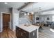 Modern living space featuring an open staircase, kitchen island with pendant lights, and open concept living at 7958 Tejon St, Denver, CO 80221
