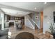 Open-concept living space with modern lighting, open staircase, and view of the kitchen at 7958 Tejon St, Denver, CO 80221