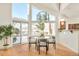 Dining area with modern light fixture, glass table, and sliding doors leading to outdoor space at 27 Tamarade Dr, Littleton, CO 80127