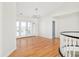Upstairs hallway featuring wood floors, chandelier, and french doors to exterior balcony at 27 Tamarade Dr, Littleton, CO 80127