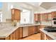 Spacious kitchen with oak cabinets, granite countertops, stainless steel appliances and natural lighting at 27 Tamarade Dr, Littleton, CO 80127