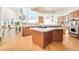 Open kitchen concept with oak cabinets, stainless steel appliances, granite countertops, and adjacent dining area at 27 Tamarade Dr, Littleton, CO 80127