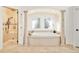 Luxurious main bathroom features a soaking tub, glass shower and designer tile at 27 Tamarade Dr, Littleton, CO 80127