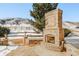 Outdoor brick fireplace features herringbone design and mountain views at 27 Tamarade Dr, Littleton, CO 80127